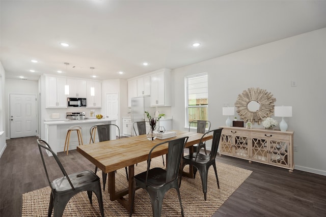 dining area featuring dark wood-type flooring