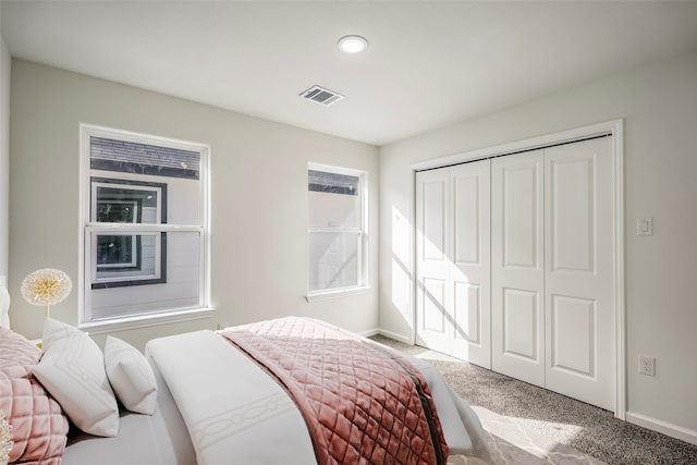 carpeted bedroom with a closet