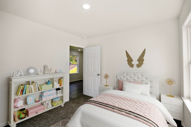 bedroom featuring dark carpet