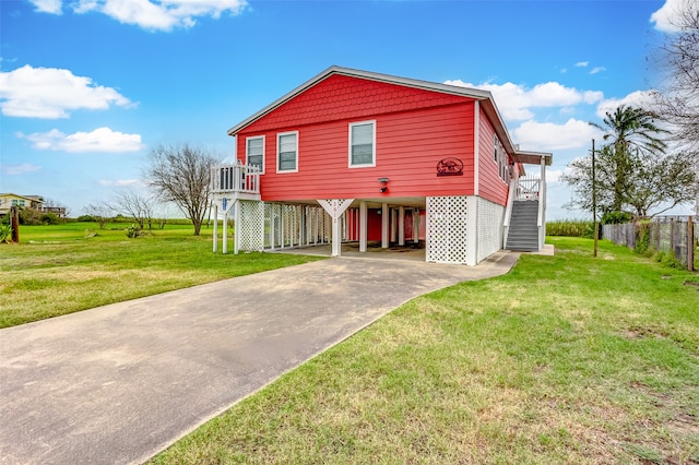 view of front of property with a front yard and a carport