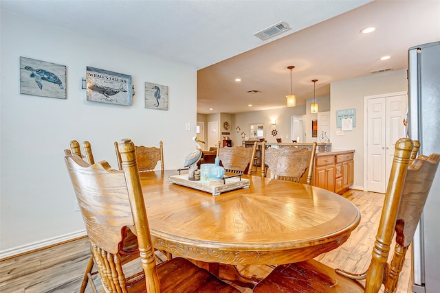 dining space with light hardwood / wood-style floors