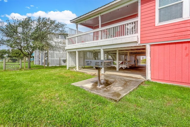 back of property with a lawn, a patio, and a deck