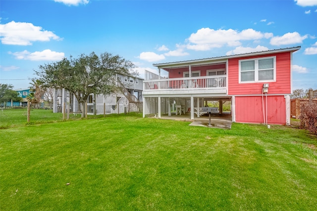 rear view of house with a lawn and a patio