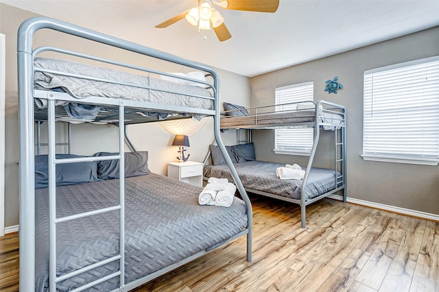 bedroom with wood-type flooring and ceiling fan