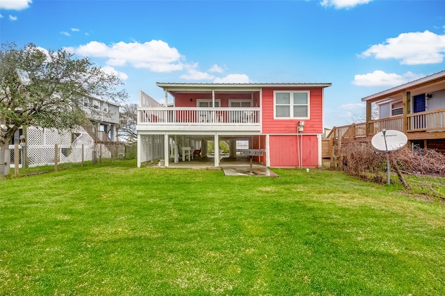 back of property with a yard and a patio