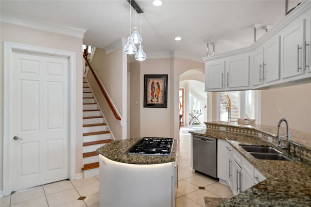 kitchen with stainless steel appliances, ornamental molding, sink, decorative light fixtures, and white cabinets