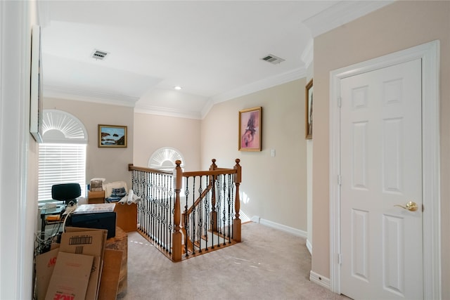 corridor featuring ornamental molding and light colored carpet