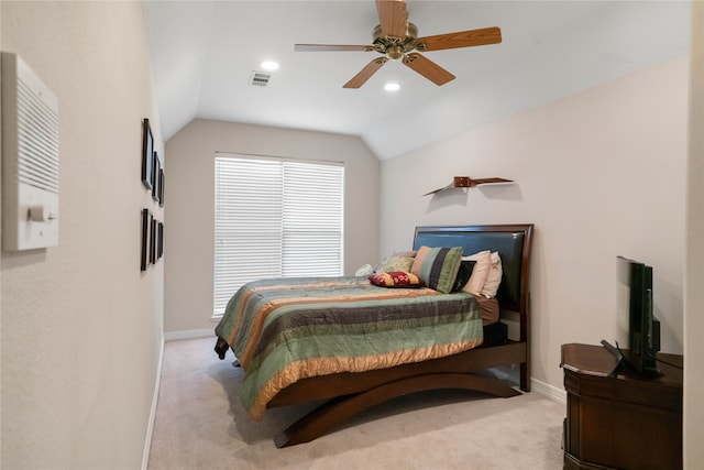 bedroom with ceiling fan, light colored carpet, and vaulted ceiling