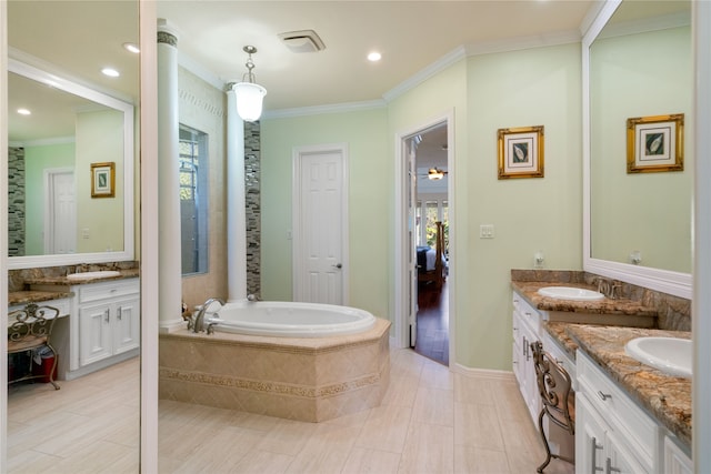 bathroom with vanity, tiled bath, crown molding, and tile patterned flooring