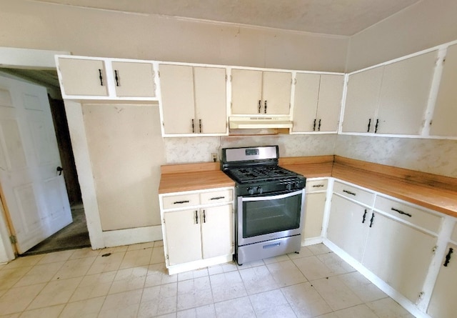 kitchen with stainless steel gas range and under cabinet range hood