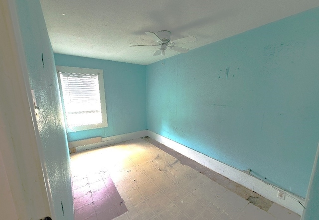 spare room with baseboards, a ceiling fan, and tile patterned floors