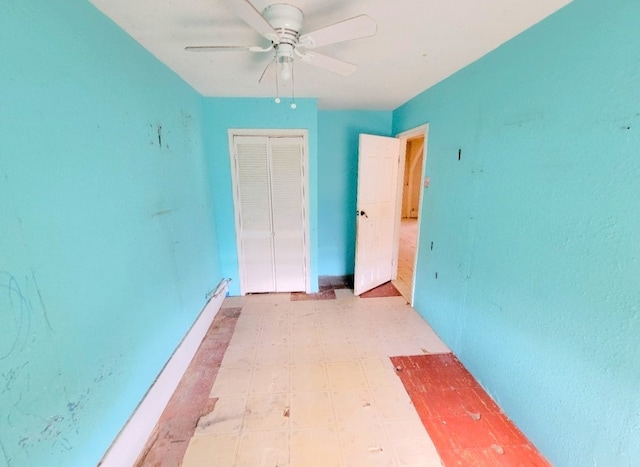 unfurnished bedroom with light floors, a closet, and a ceiling fan