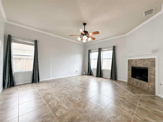 unfurnished living room featuring a textured ceiling, crown molding, ceiling fan, and a tile fireplace