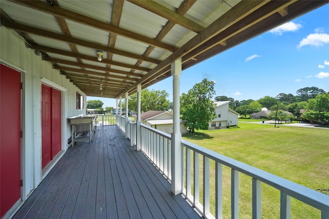 wooden deck featuring a yard