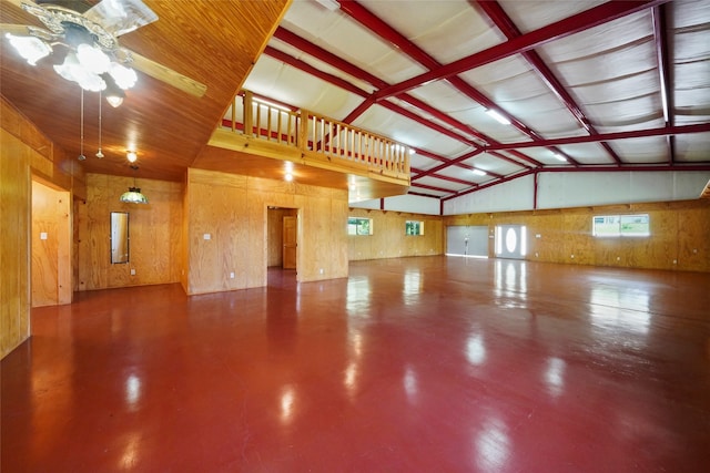 garage with ceiling fan and wooden walls