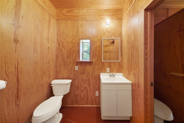 bathroom with wood ceiling, toilet, wooden walls, and vanity