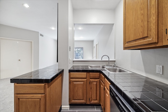 kitchen with dishwasher, kitchen peninsula, sink, and tile countertops