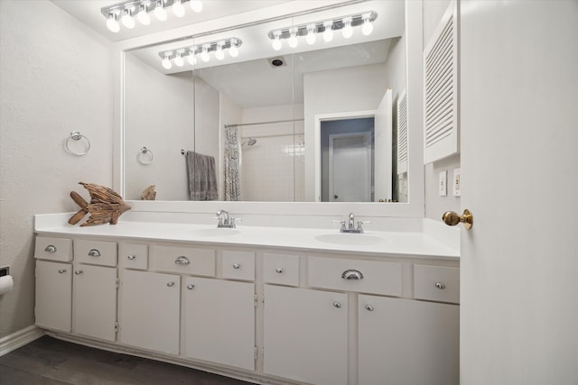 bathroom featuring walk in shower, hardwood / wood-style flooring, and vanity