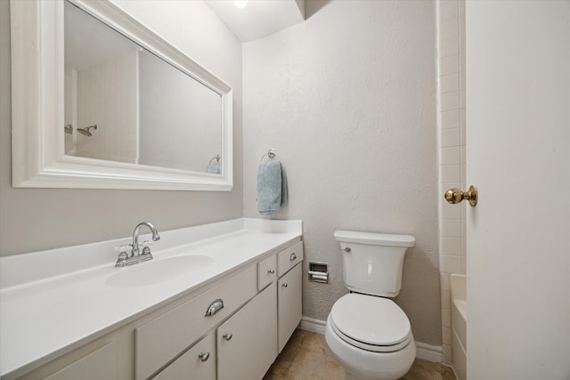 bathroom with tile patterned flooring, toilet, and vanity