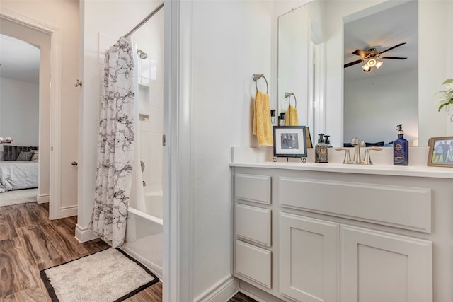 bathroom featuring vanity, hardwood / wood-style floors, ceiling fan, and shower / bath combination with curtain