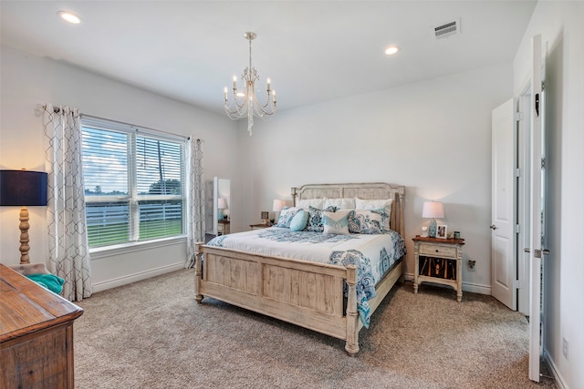 bedroom with carpet floors and an inviting chandelier