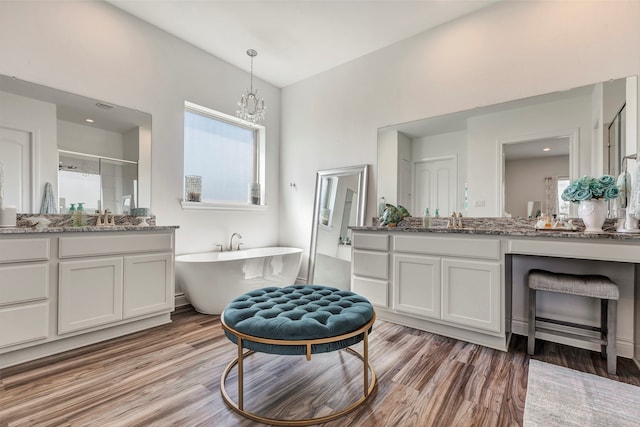 bathroom with shower with separate bathtub, vanity, and hardwood / wood-style floors