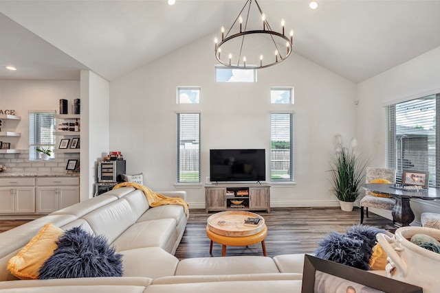 living room with a notable chandelier, plenty of natural light, and dark hardwood / wood-style floors