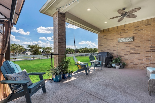 view of patio with area for grilling and ceiling fan