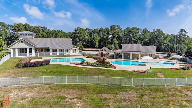 view of swimming pool featuring a yard and a patio area