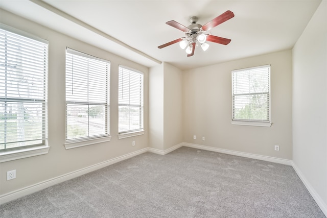 spare room featuring ceiling fan and light colored carpet