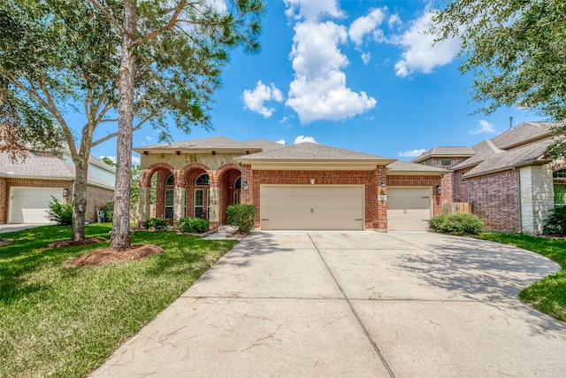 view of front of home with a garage and a front yard