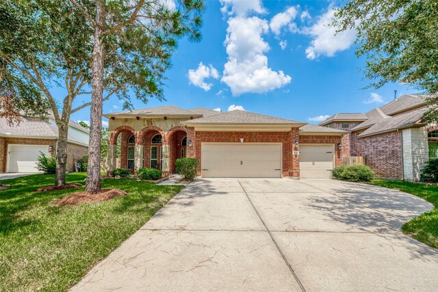 view of front of property with a garage and a front yard