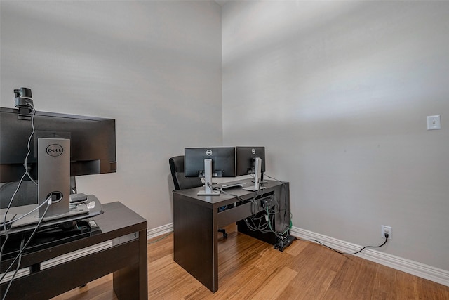 office with light wood-style flooring and baseboards