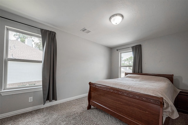 bedroom featuring visible vents, carpet floors, and baseboards