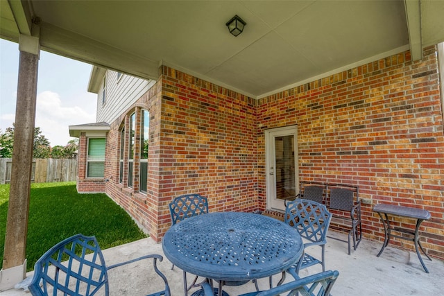 view of patio / terrace featuring outdoor dining area and fence