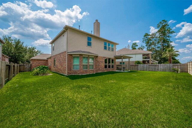 back of house featuring a lawn