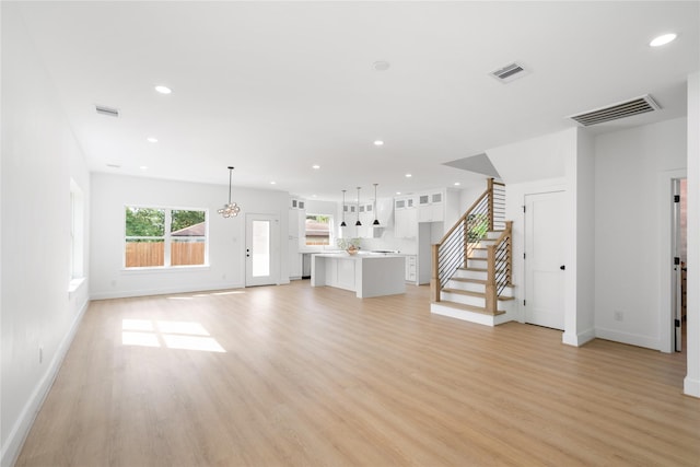 unfurnished living room with light wood-type flooring