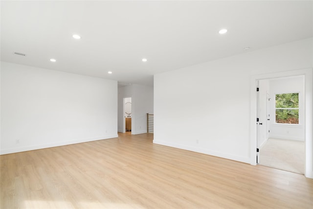 spare room featuring light hardwood / wood-style floors