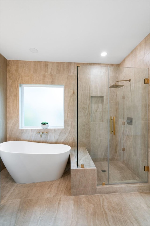 bathroom featuring shower with separate bathtub