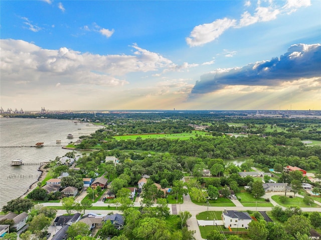 aerial view at dusk featuring a water view