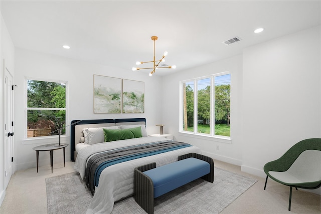 carpeted bedroom with a notable chandelier