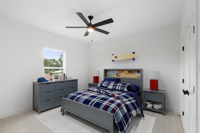 bedroom with light carpet and ceiling fan