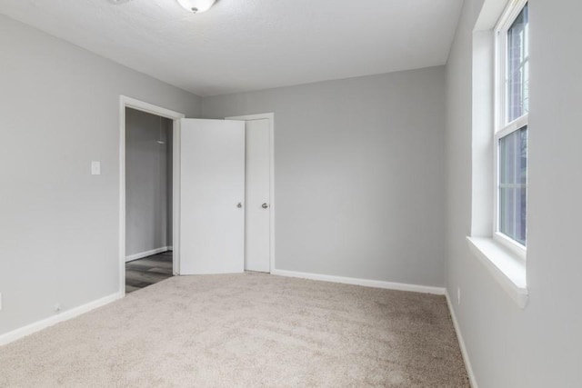 unfurnished bedroom featuring carpet flooring and a closet