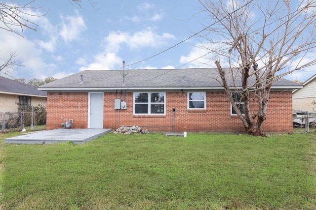 back of house with a yard and a patio area