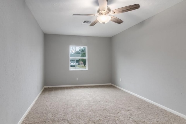 empty room with ceiling fan and carpet