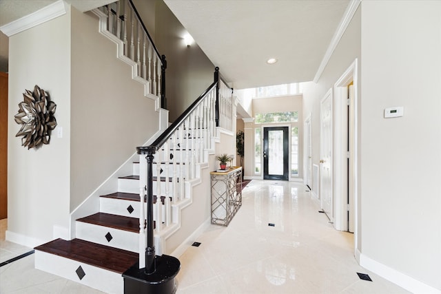 entryway featuring crown molding, french doors, and a textured ceiling