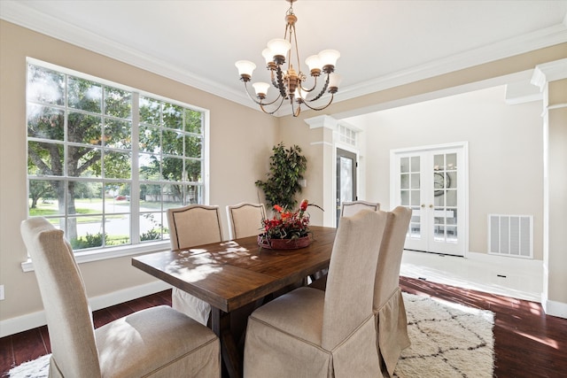 dining space with a healthy amount of sunlight, an inviting chandelier, and dark wood-type flooring