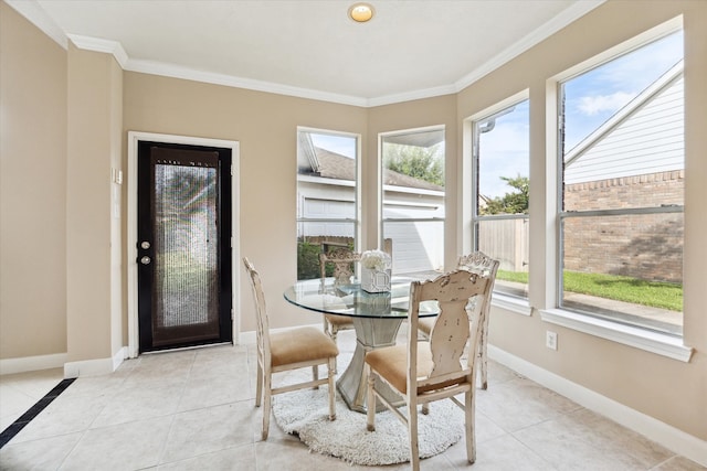 dining room featuring light tile patterned floors, a wealth of natural light, and crown molding