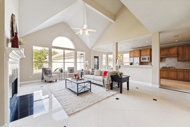 living room with a premium fireplace, high vaulted ceiling, light tile patterned flooring, and ceiling fan