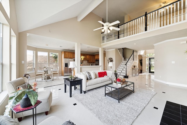 living room featuring beamed ceiling, high vaulted ceiling, and ceiling fan